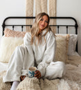 Load image into Gallery viewer, Woman sitting on a bed wrapped in a white blanket holding a mug. - Thread Vision Spotlight, Hill x Sarah, Sarah Hill