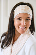 Load image into Gallery viewer, Woman wearing a beige headband and white robe against a neutral background - Thread Vision Spotlight, Remington Avenue