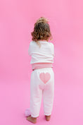 Load image into Gallery viewer, Child wearing a white sweater and sweatpants outfit with pink hearts on a pink background - Thread Vision Spotlight, Rydel