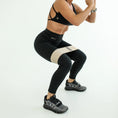 Load image into Gallery viewer, Person wearing black athletic leggings with beige accent and black sports bra, performing a squat on a white background.- Thread Vision Spotlight, Day 1 Fitness, Kaylee Rogers