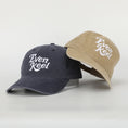 Load image into Gallery viewer, Two baseball caps, one navy and one beige, with 'Even Keel' logo on a light gray background. - Thread Vision Client Spotlight