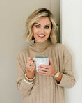 Load image into Gallery viewer, Woman holding a mug indoors wearing a beige sweater. - Thread Vision Spotlight, Loverly Grey
