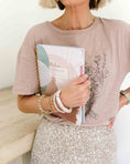 Load image into Gallery viewer, Person holding a notebook with floral design, wearing a pink shirt and silver skirt. - Thread Vision Spotlight, Loverly Grey