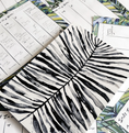 Load image into Gallery viewer, Black and white palm leaf design on a white surface with other decorative elements. - Thread Vision Client Spotlight, Goldfish Kiss