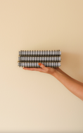 Load image into Gallery viewer, Hand holding a black and white checkered stack of paper planners against a beige background - Thread Vision Client Spotlight, Skinny Hangover