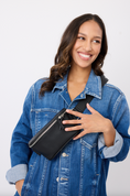 Load image into Gallery viewer, Woman holding a black fanny pack against a white background - Thread Vision Client Spotlight, RESET by Serena Pitt