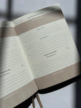 Load image into Gallery viewer, Open notebook with lined pages on a blurred background Thread-Vision-Karina-Faith-Diaries