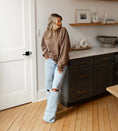 Load image into Gallery viewer, Woman standing in a modern kitchen with dark cabinets and light wood flooring. - Thread Vision Spotlight, Hill x Sarah, Sarah Hill