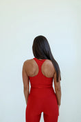 Load image into Gallery viewer, Person wearing a red outfit with an open back on a white background - Thread Vision Spotlight, Day 1 Fitness, Kaylee Rogers