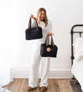 Load image into Gallery viewer, Woman holding two black bags in a bedroom setting - Thread Vision Spotlight, Hill x Sarah, Sarah Hill