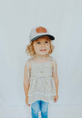 Load image into Gallery viewer, Child wearing a cap and floral dress against a white background - Thread Vision Client Spotlight, Cheerfully U by Alyssa Webster