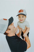 Load image into Gallery viewer, Man holding a child wearing matching baseball caps against a white background - Thread Vision Client Spotlight, Cheerfully U by Alyssa Webster