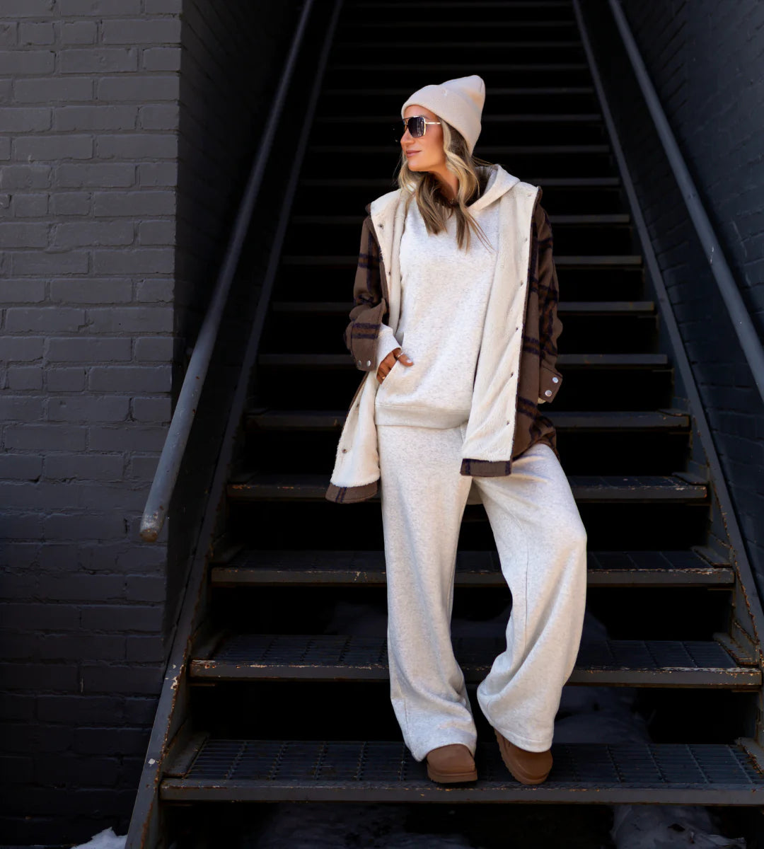 Person wearing a stylish outfit with a coat, hoodie, and pants on a staircase. - Thread Vision Spotlight, Hill x Sarah, Sarah Hill 