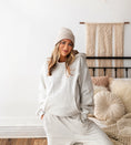Load image into Gallery viewer, Woman wearing a gray loungewear set in a cozy bedroom. - Thread Vision Spotlight, Hill x Sarah, Sarah Hill 
