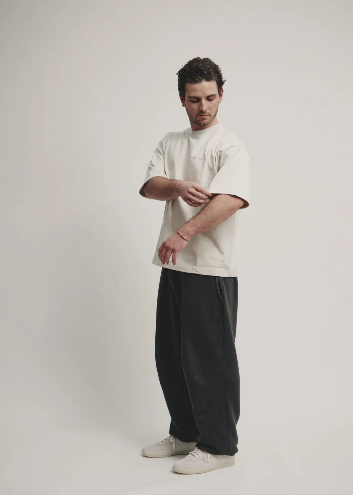 Man wearing a white shirt and black pants on a plain background - Thread Vision Spotlight, Kinda Handsome