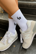 Load image into Gallery viewer, Beige sneakers and white socks with a logo on a stone surface - Thread Vision Spotlight, Ignited Apparel
