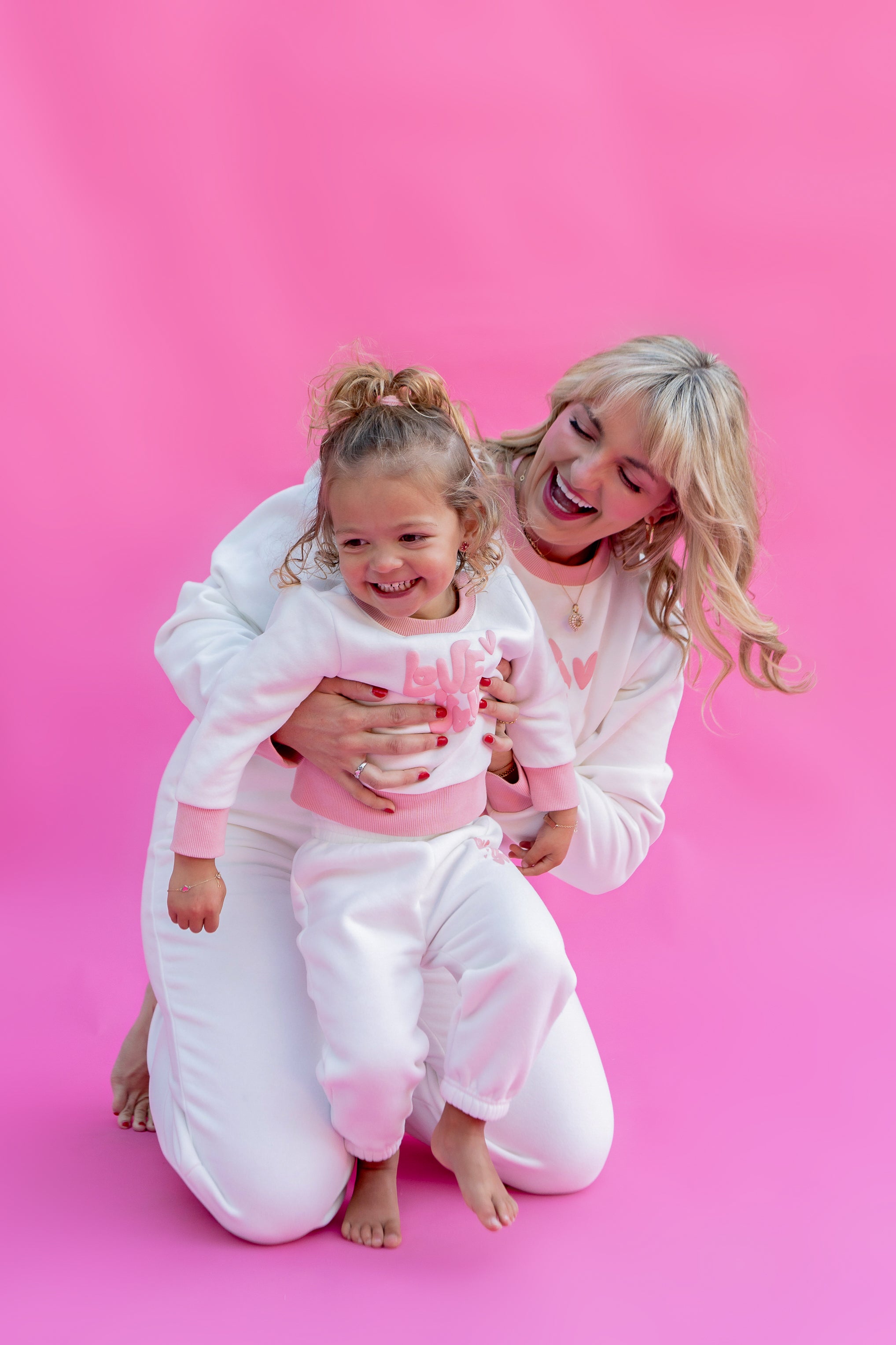 Woman and child in matching pink and white sweater outfits on a pink background - Thread Vision Spotlight, Rydel