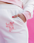 Load image into Gallery viewer, White sweatpants with pink text 'LOVE YOU' on a pink background - Thread Vision Spotlight, Rydel
