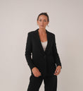 Load image into Gallery viewer, Woman wearing a black suit against a plain background - Thread Vision Spotlight, Loe Hayley
