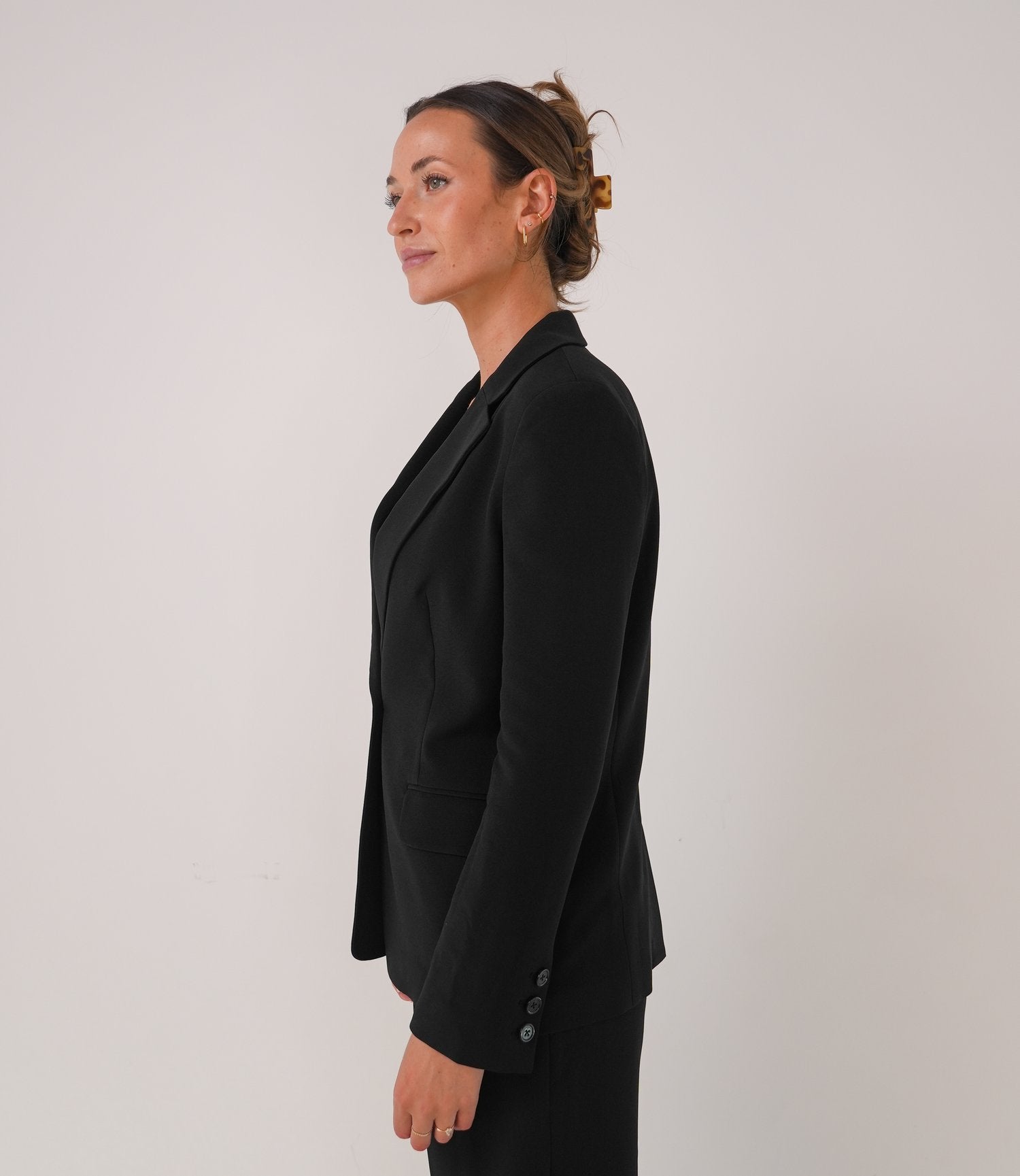 Woman wearing a black blazer against a plain background - Thread Vision Spotlight, Loe Hayley