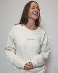 Load image into Gallery viewer, Woman wearing a white sweatshirt with 'TOODALOOG' text on a plain background - Thread Vision Spotlight, Loe Hayley
