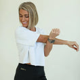 Load image into Gallery viewer, Woman wearing a smartwatch on her wrist against a plain background - Thread Vision Spotlight, Day 1 Fitness, Kaylee Rogers 

