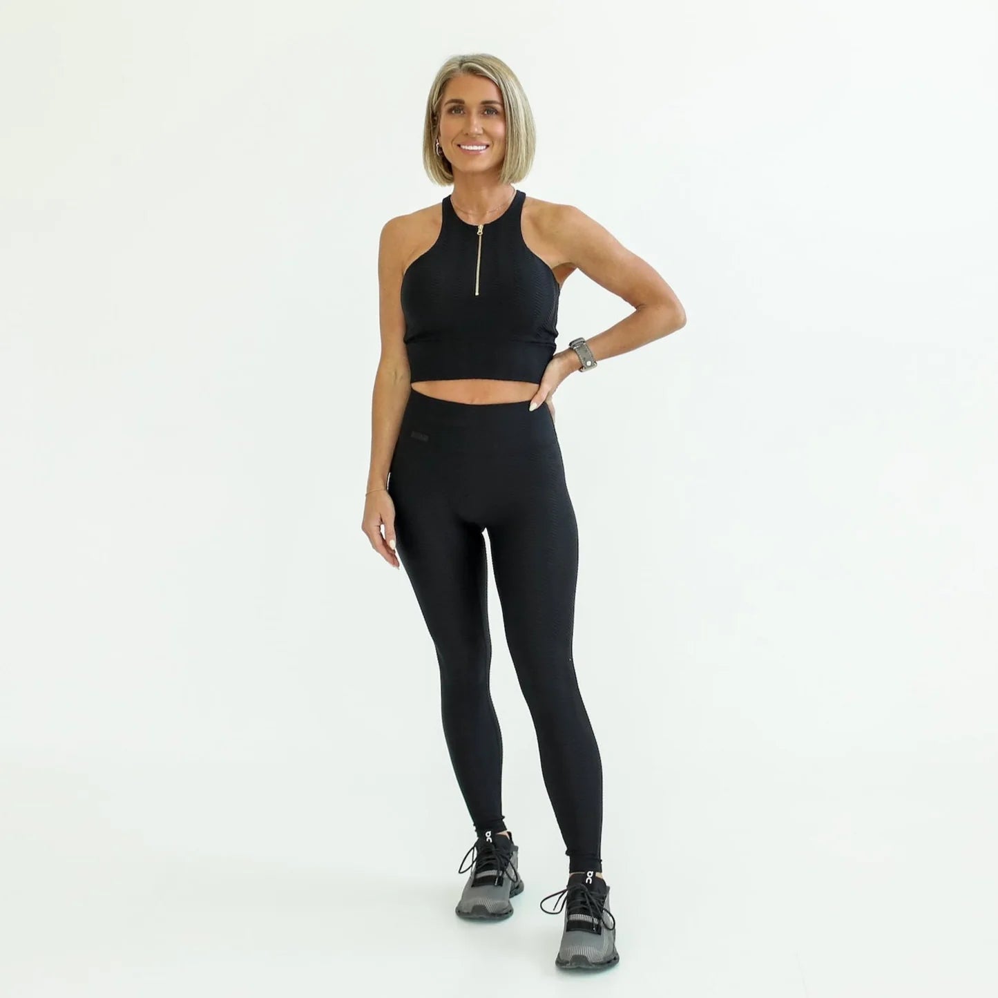 Woman wearing a black athletic outfit on a white background - Thread Vision Spotlight, Day 1 Fitness, Kaylee Rogers 