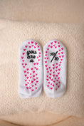 Load image into Gallery viewer, Pair of socks with heart patterns and text on a beige surface - Thread Vision Client Spotlight, 10/10 Deanna Giulietti 

