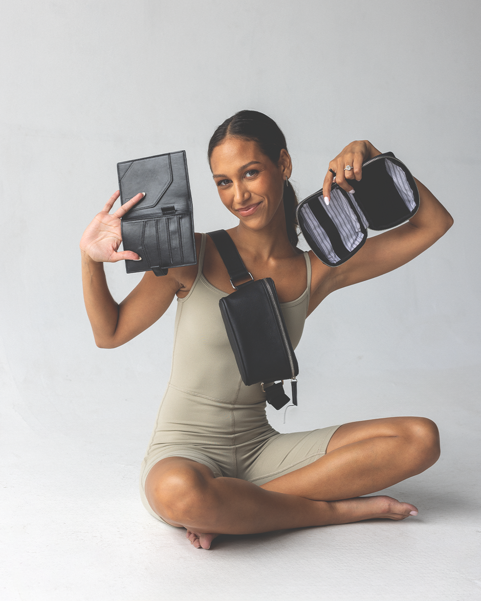 Woman holding a passport wallet and an accessory case, wearing a black fanny pack bag, against a white background - Thread Vision Client Spotlight, RESET by Serena Pitt
