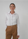 Load image into Gallery viewer, Woman wearing a white shirt and brown pants against a plain background - Thread Vision Spotlight, Loe Hayley

