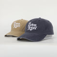 Load image into Gallery viewer, Two baseball caps, one beige and one navy, with 'Even Keel' logo on a light gray background. - Thread Vision Client Spotlight
