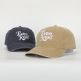 Load image into Gallery viewer, Two baseball caps, one navy and one beige, with 'Even Keel' text on a white background. - Thread Vision Client Spotlight
