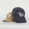 Load image into Gallery viewer, Two baseball caps, one beige and one navy, with 'Even Keel' logo on a white background - Thread Vision Client Spotlight
