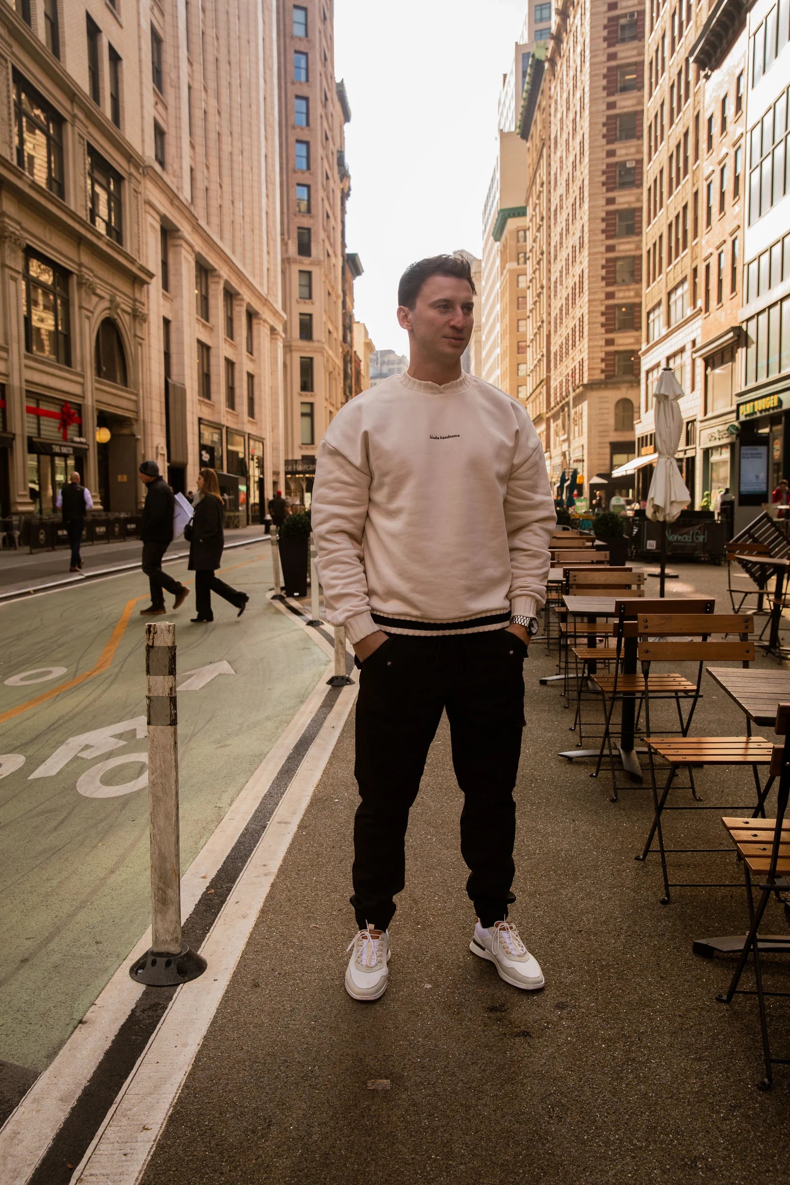 Man standing on a city street with buildings and tables in the background - Thread Vision Spotlight, Kinda Handsome