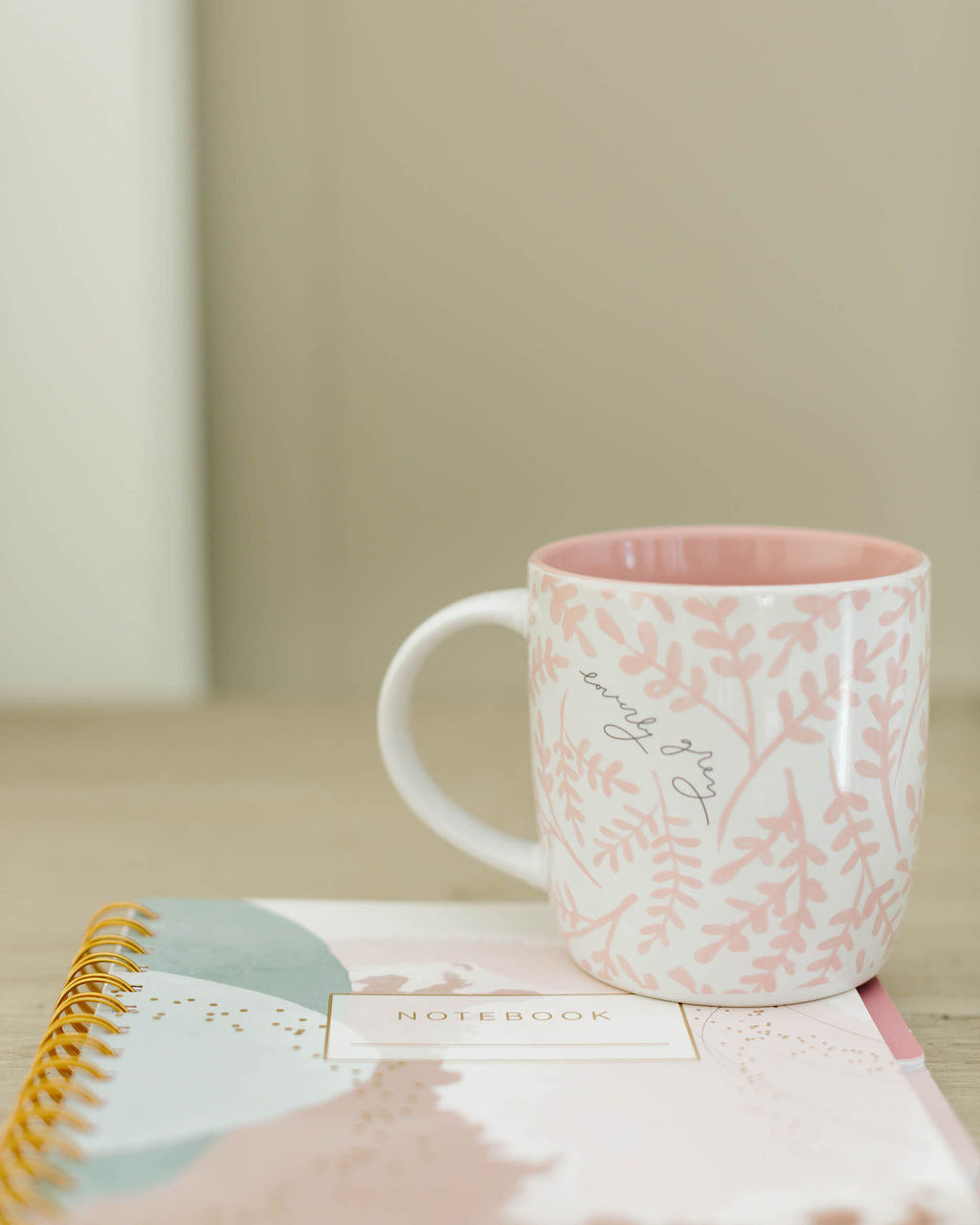 Pink mug with floral pattern on a notebook against a neutral background - Thread Vision Spotlight, Loverly Grey