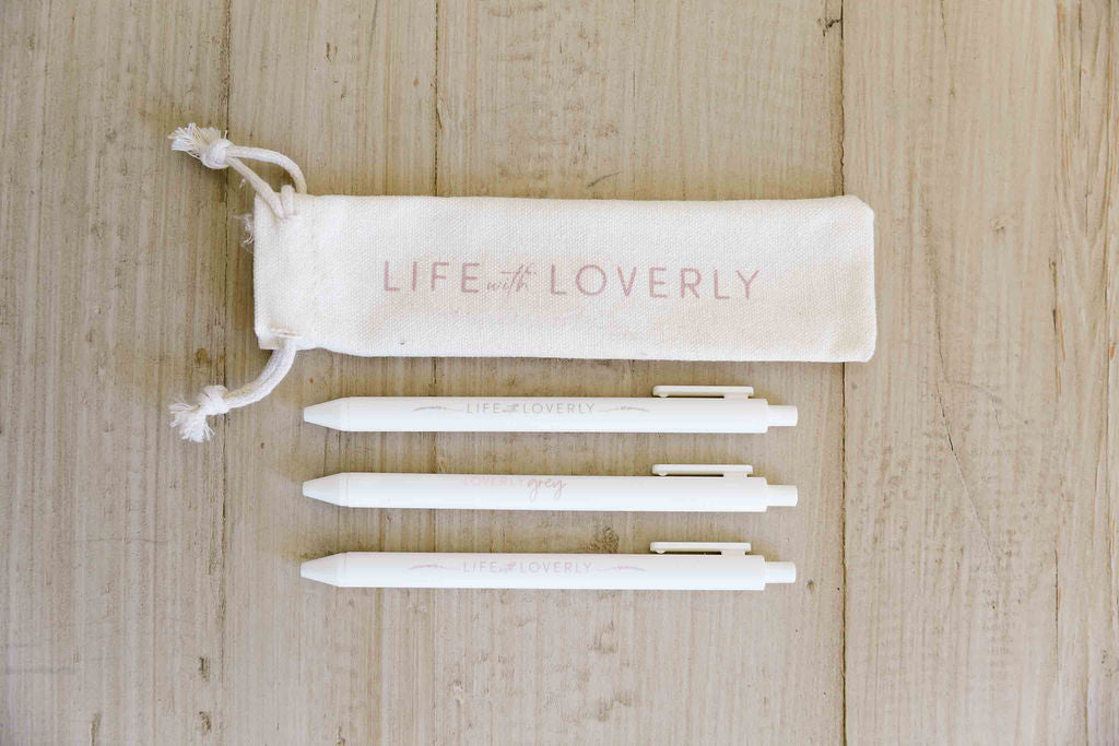 Set of white pens with a 'Life Loverly' pouch on a wooden surface - Thread Vision Spotlight, Loverly Grey