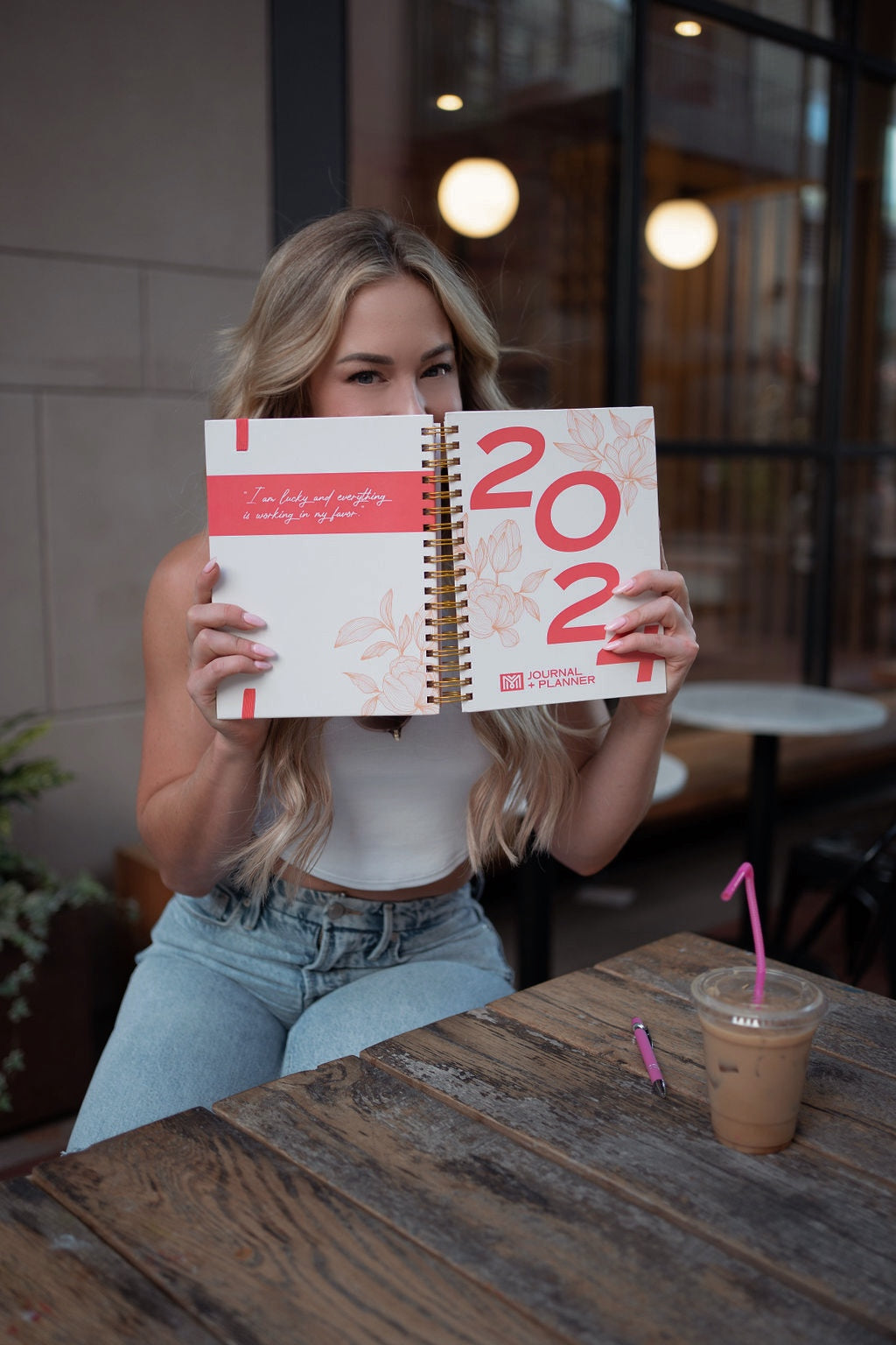Woman holding a 2022 planner at a cafe - - Thread Vision Spotlight, Move Like Morgan