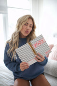 Load image into Gallery viewer, Woman holding a 2023 planner in a bright room - Thread Vision Spotlight, Move Like Morgan
