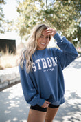 Load image into Gallery viewer, Woman wearing a blue sweatshirt with 'STRONG is sexy' text outdoors. - Thread Vision Spotlight, Move Like Morgan
