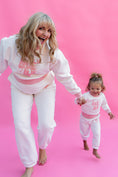 Load image into Gallery viewer, Woman and child in matching pink sweater outfits against a pink background - Thread Vision Spotlight, Rydel
