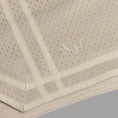 Load image into Gallery viewer, Beige textured fabric with embroidered initials on a gray background - Thread Vision Spotlight, Kinda Handsome

