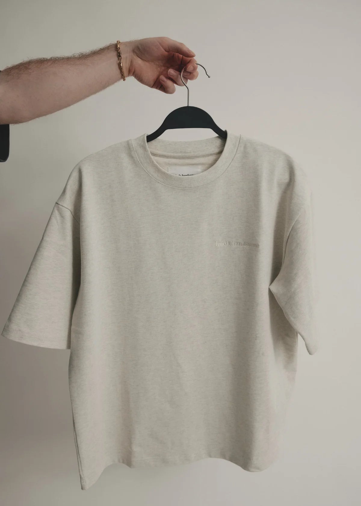 Beige t-shirt on a hanger against a plain background - Thread Vision Spotlight, Kinda Handsome