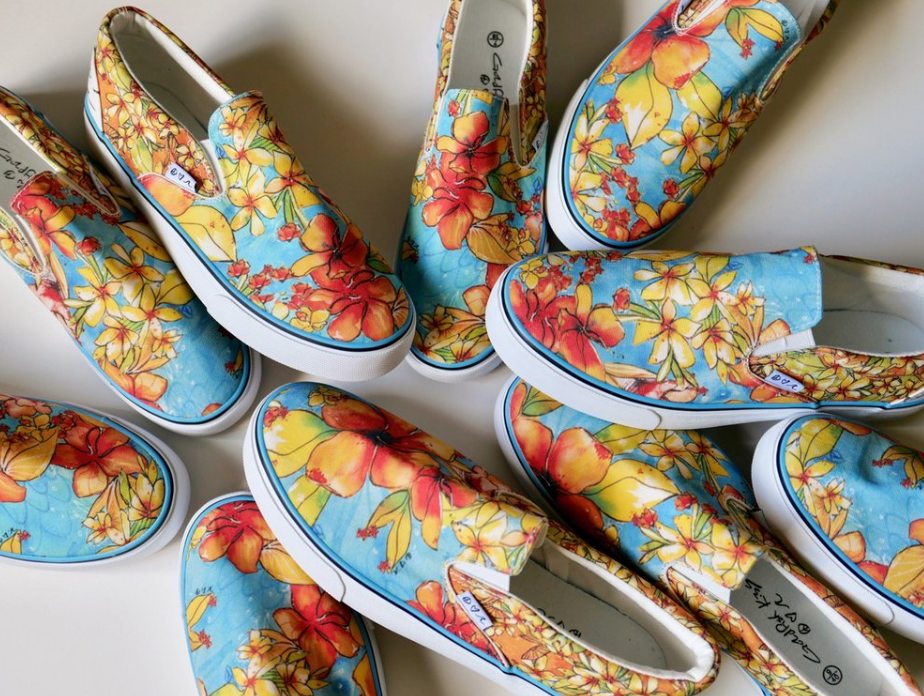 Colorful floral-patterned slip-on shoes stacked on a white surface - Thread Vision Client Spotlight, Goldfish Kiss