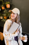 Load image into Gallery viewer, Woman holding a notebook and a coffee cup in a casual setting - Thread Vision Spotlight, Skinny Hangover
