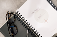 Load image into Gallery viewer, Spiral-bound planner with glasses on a textured surface - Thread Vision Client Spotlight, Skinny Hangover
