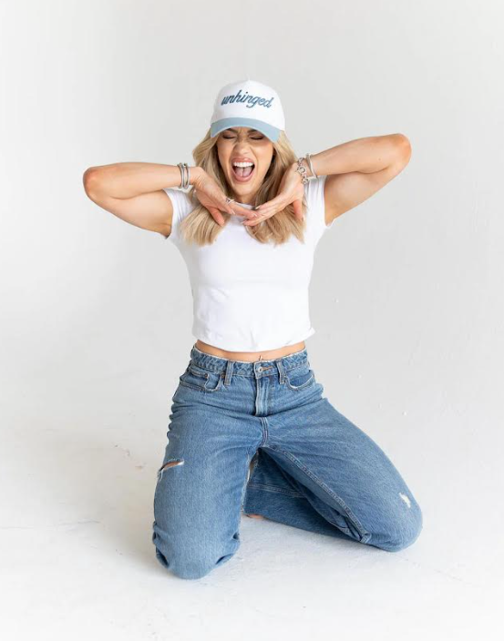 Person wearing a white crop top, blue jeans, and a white cap with text on a plain background - Thread Vision, Client Move Like Morgan
