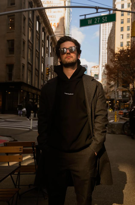 Man wearing sunglasses and a black jacket on a city street - Thread Vision, Client Kinda Handsome