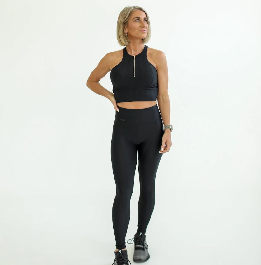 Woman wearing a black athletic outfit on a white background - Thread Vision, Client Day 1 Fitness