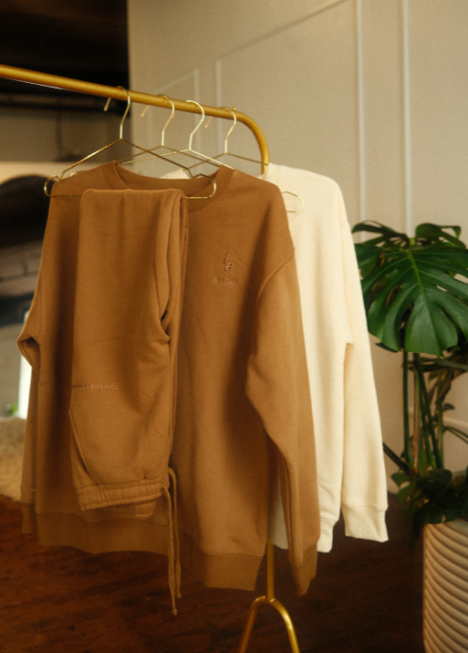 Brown jacket and white shirt on hangers with a plant in the background - Thread Vision, Client Ignited Apparel