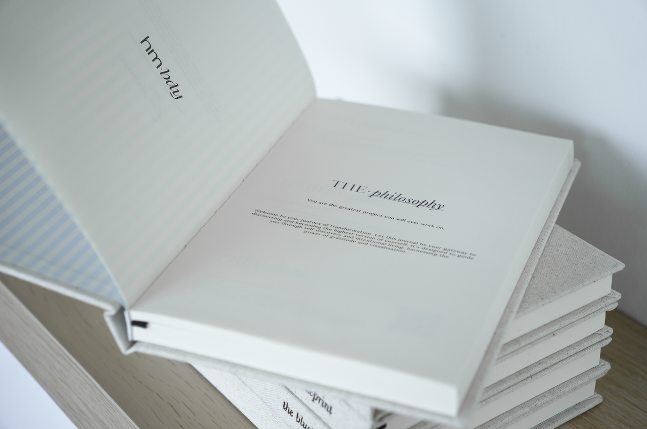 Stack of white books with text on a light background- Thread Vision Spotlight, HMBDY